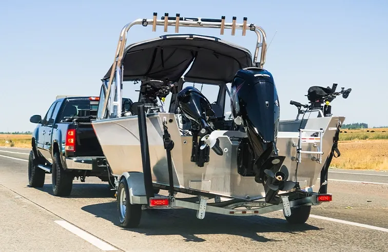 Aluminum fishing boat on a trailer being transported across Florida