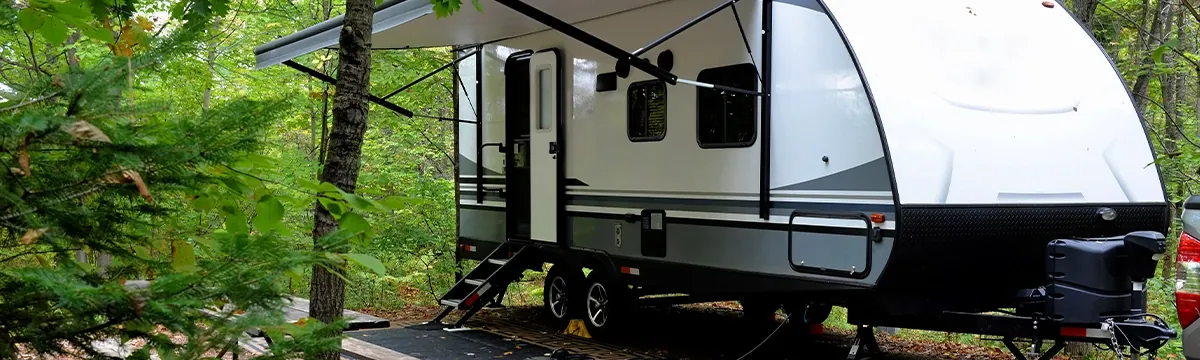 Travel trailer camper parked at a wooded campsite in Florida